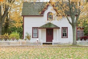 small nice little house lawn leaves white picket fence