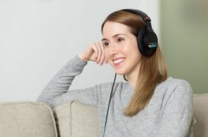girl listing on headphones
