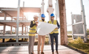 construction_with_three_people_holding_plans
