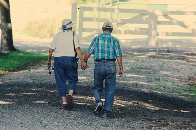 older couple walking and holding hands