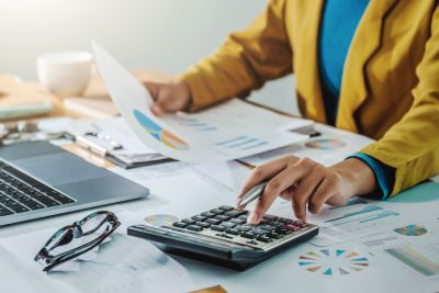 calculator and charts held by person