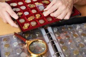 Numismatist with his collection of coins